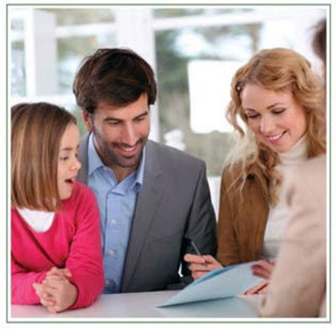 Adults and a child looking at materials together during a consultation